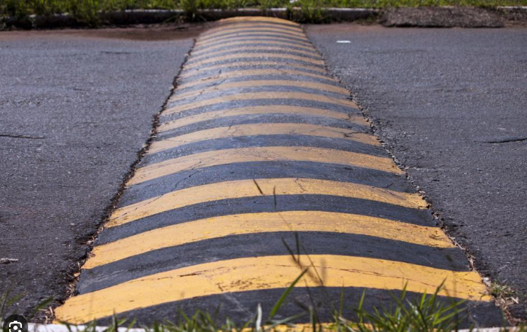 Real striped speed bump raised across a road