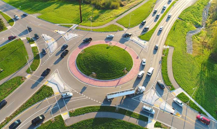 Aerial view of a real traffic roundabout with cars circulating around a center island